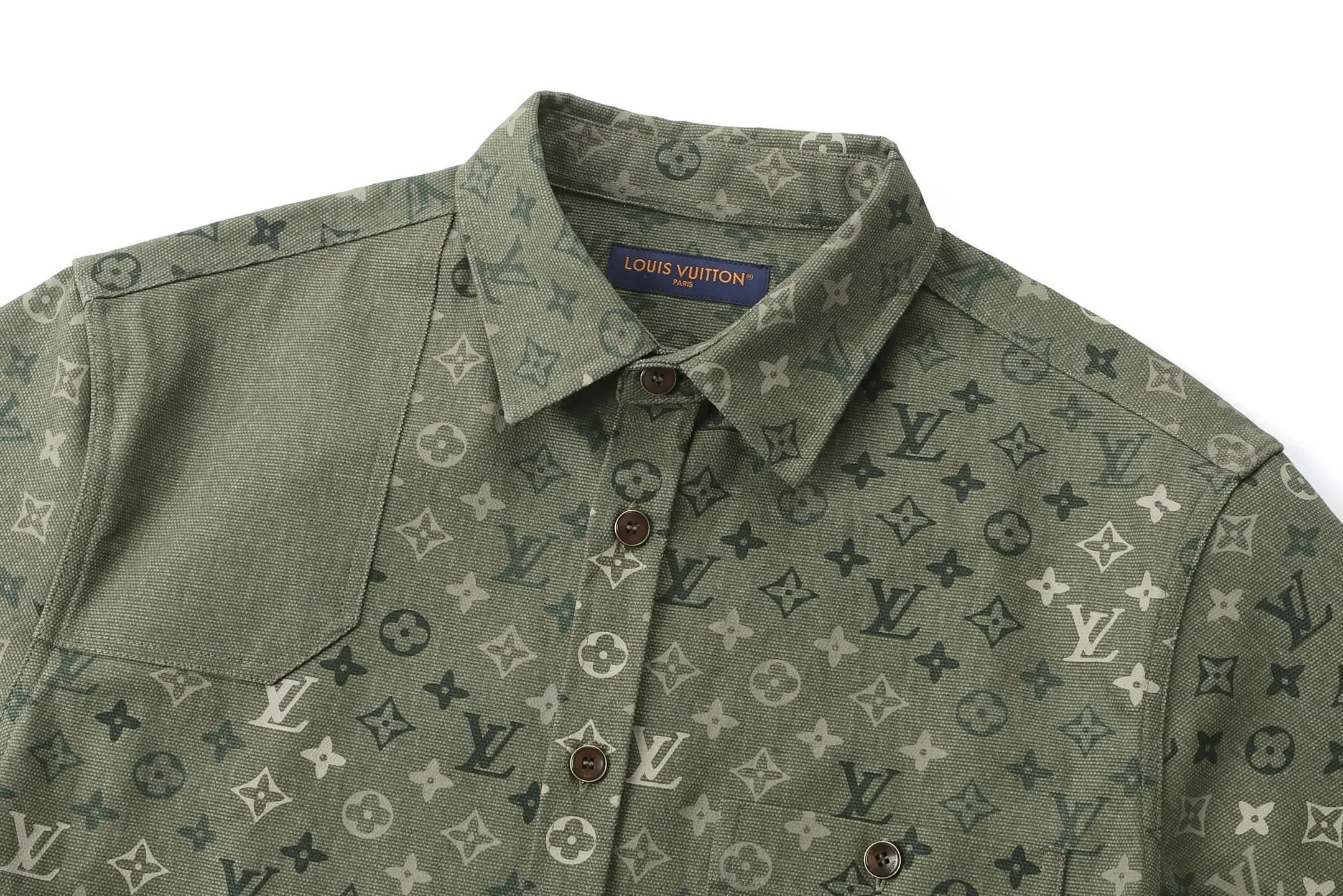 🅿️600 1v 25SS full-print green camouflage work jacket style shirt. The original purchase was 16,000 and developed. The fabric is made of custom-dyed 50-count plain double-ply pique cotton. Before positioning and cutting the fabric pieces, digital typesetting is used to lock the position of the full-print Monogram pattern to ensure that the pattern is continuous and without misalignment after splicing. The pattern alignment error between the body and the solid color splicing area is controlled within 0.5cm. The printing process uses digital direct injection technology: the pigment penetrates the fabric fibers with micron-sized particles, presenting a low-saturation vintage tone while maintaining the breathability of the fabric. The wear resistance of the printing layer reaches level 5 (friction test ≥ 200 times without falling off). The body is made of twill canvas blended fabric, and the splicing parts are reinforced with double-needle buried clip technology. The buttons are made of brass-plated matte paint, and the stitching is made of high-tenacity nylon thread with a tensile strength of 150N. The overall process takes into account both visual integrity and practical durability. The overall wiring is straight and delicate, the fabric is comfortable and soft, and the color is consistent without color difference. It can be matched with the same style to create a fashionable look and control various occasions. Customized accessories, complete with three standards, the same style for men and women. Size:S-M-L-XL